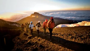 Climbers trekking on Mount Kilimanjaro’s Machame Route during sunrise